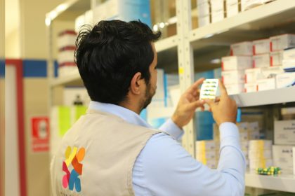 a man taking a picture of a product in a store