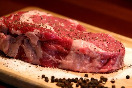a piece of raw meat on a cutting board