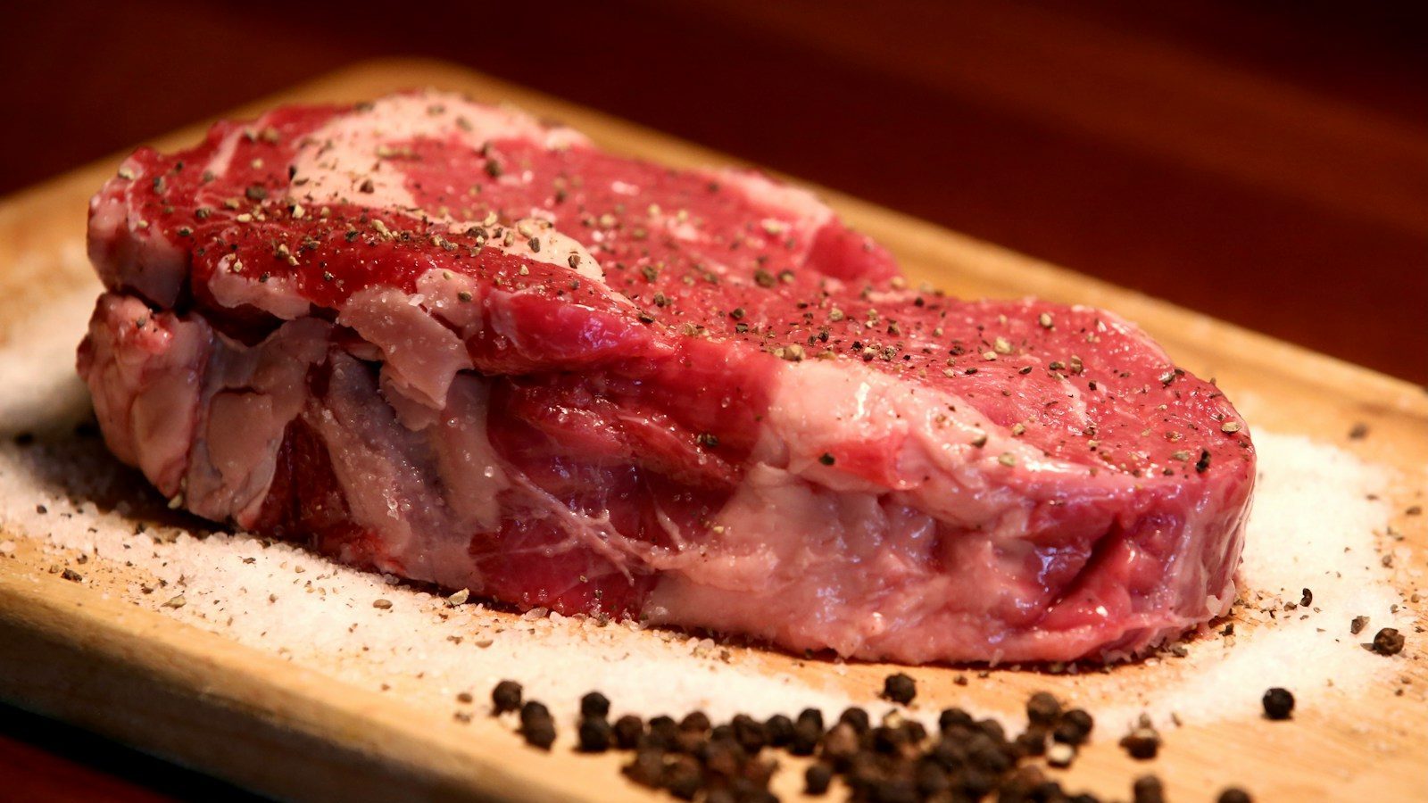 a piece of raw meat on a cutting board