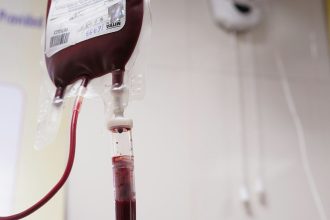 a blood test tube with a blood dropper attached to it